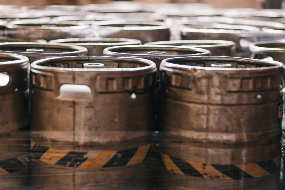 Metal beer kegs packed together tightly.