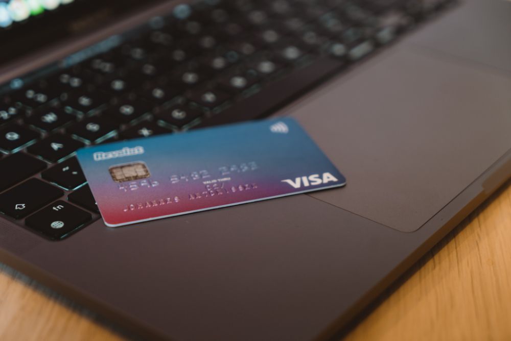 Revolut Visa card sitting on grey laptop keyboard.