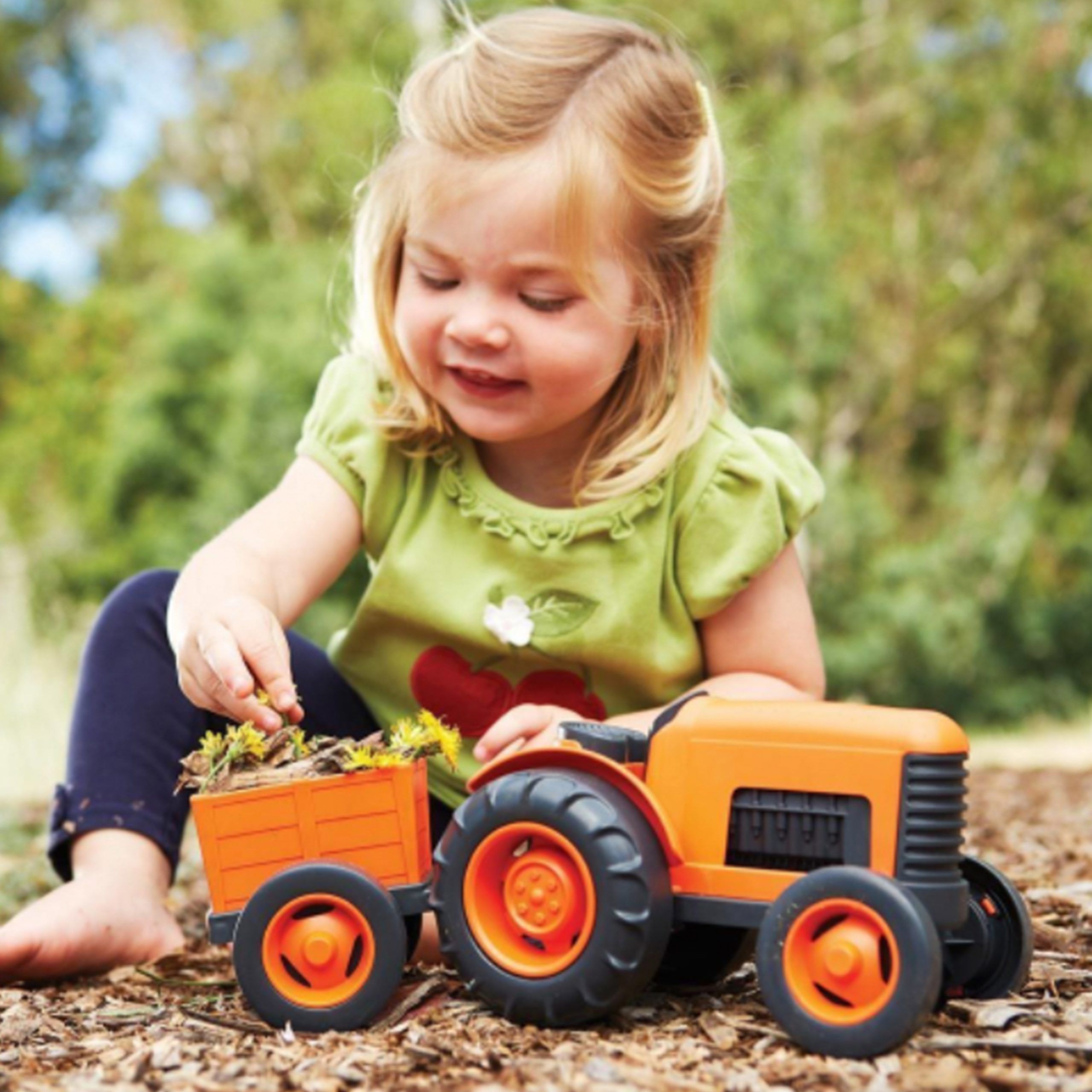 A child playing with a toy tractor from Whirli