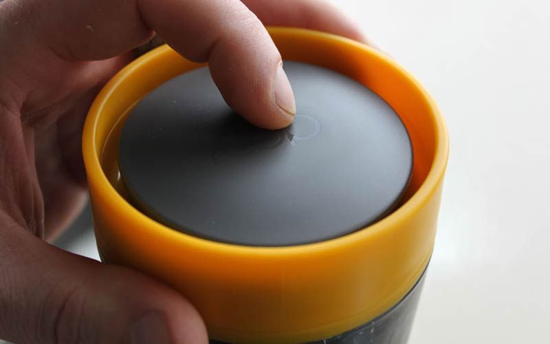 Circular Cup lid closed, press to open