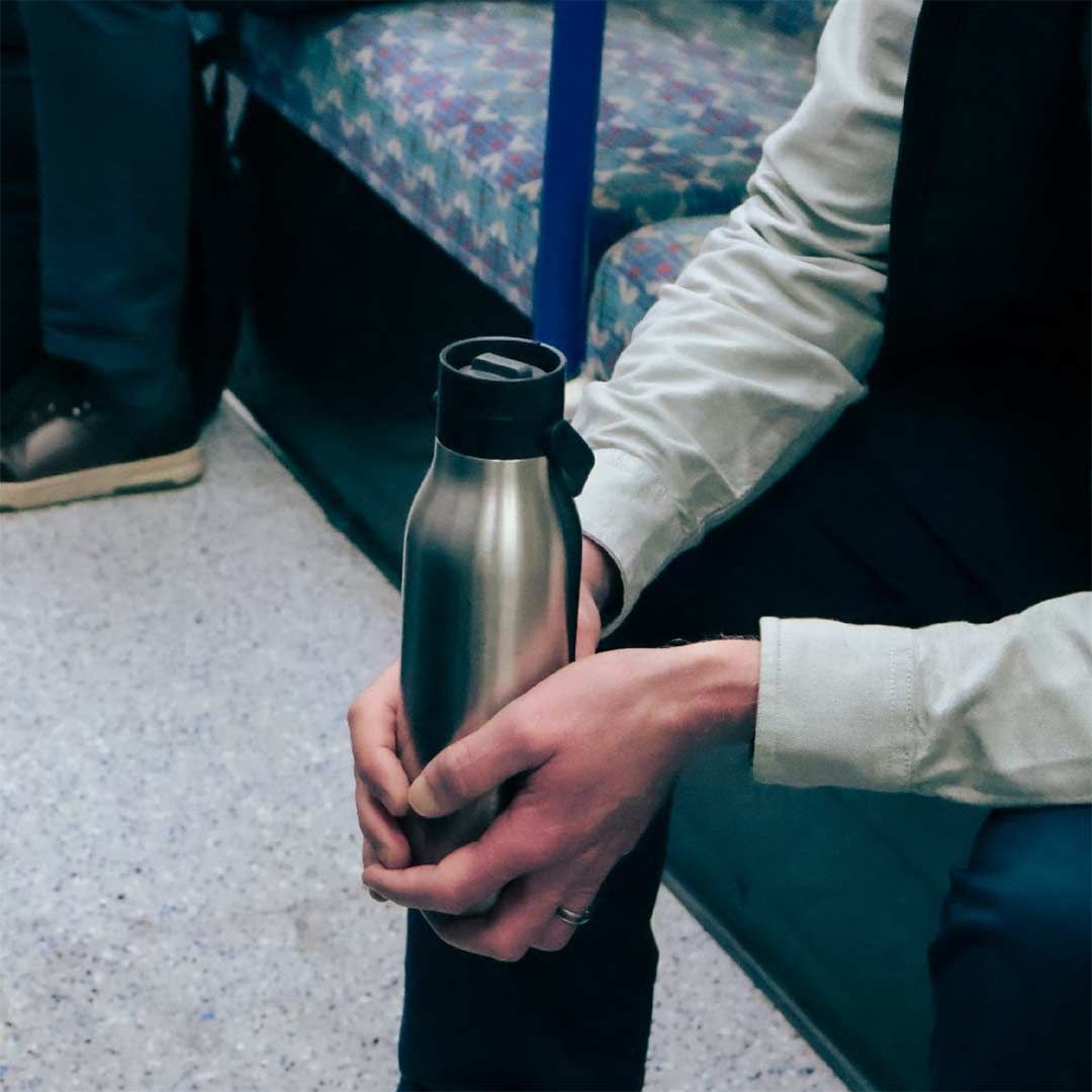 Man with a Circular and Co bottle on the train.