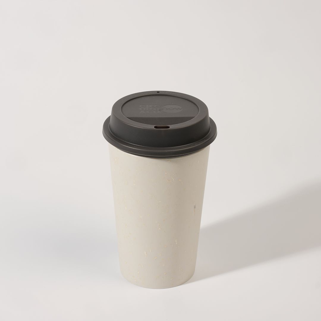 white reusable cup with black lid