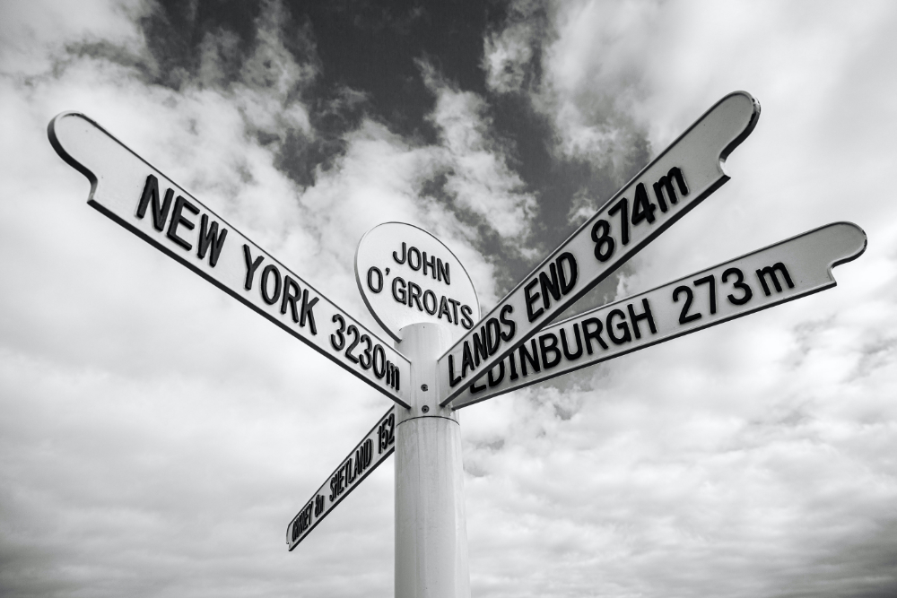 Road sign at John' O Groats pointing to Land's End and New York.