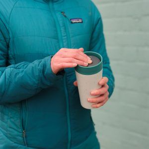 white reusable cup with green lid