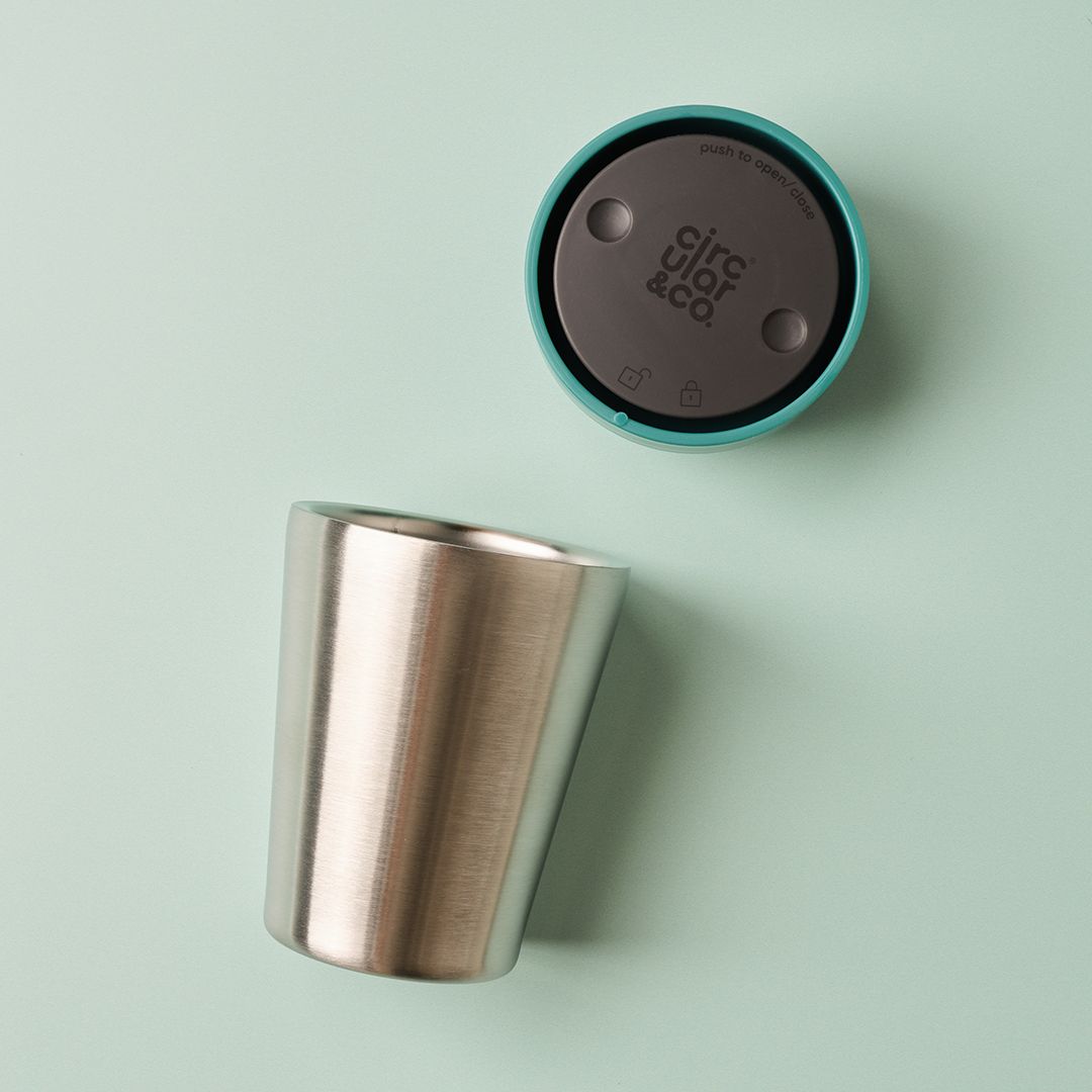 steel reusable cup with green lid