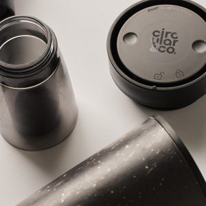 black reusable cup next to black lid