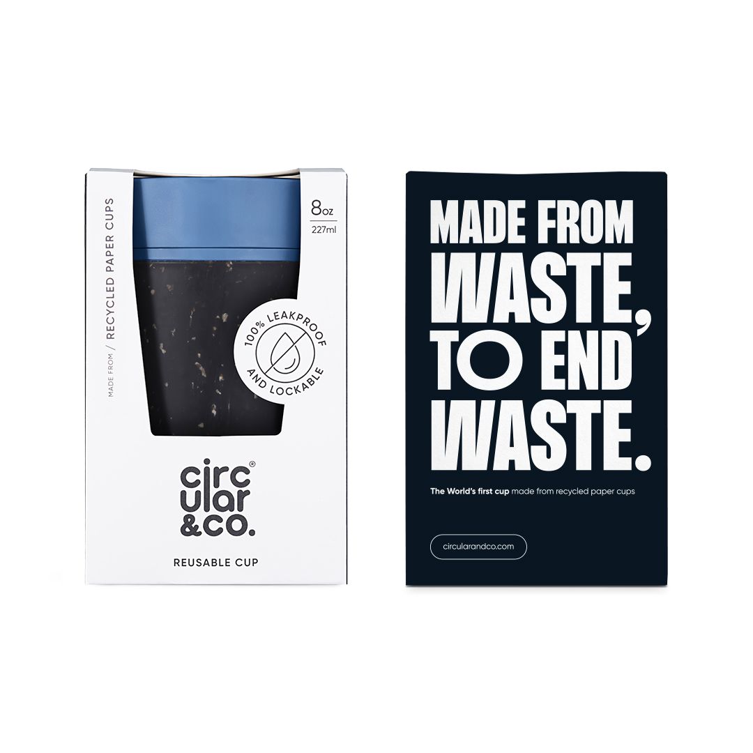 black reusable cup with blue lid in cardboard packaging