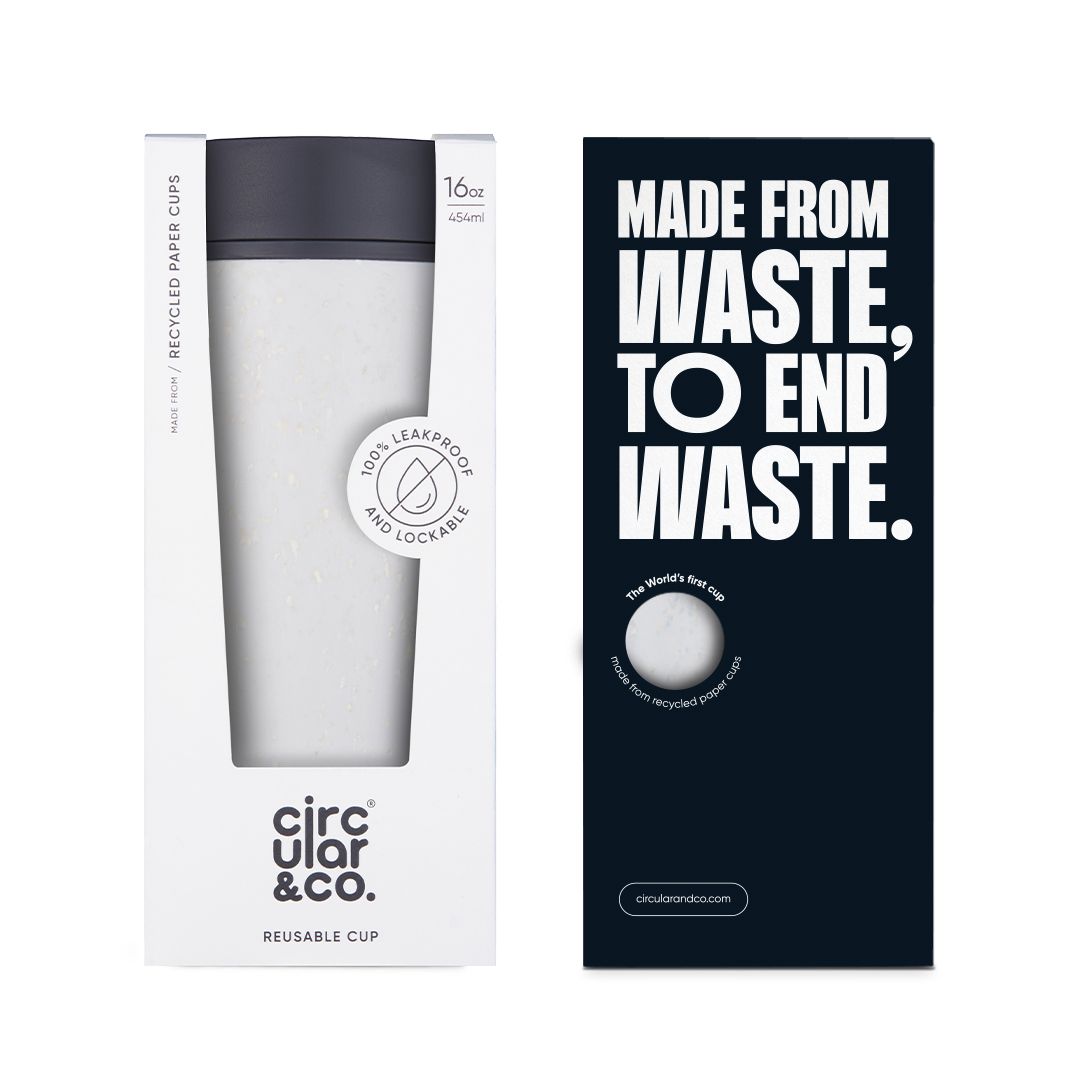 white reusable cup with black lid in cardboard packaging
