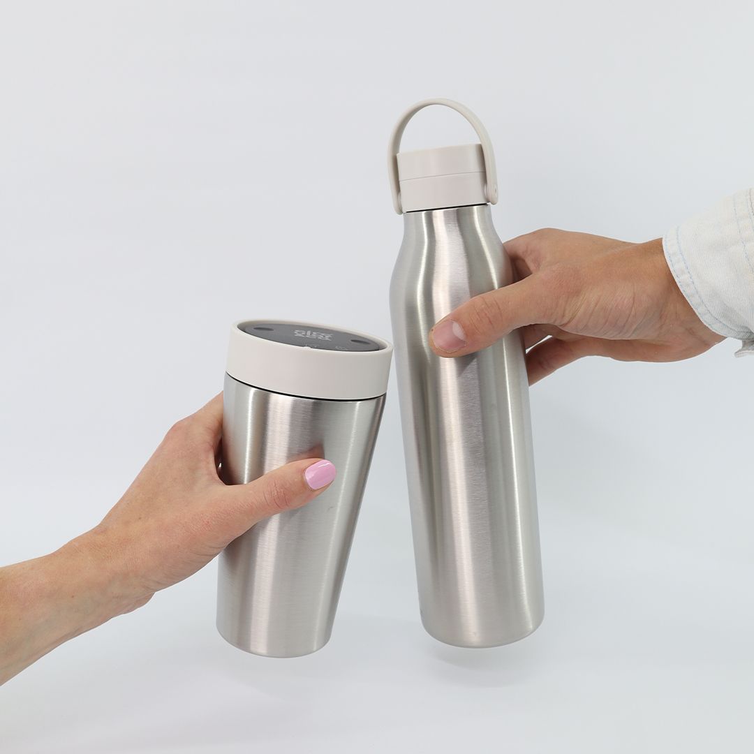 12oz Stainless Steel Reusable Travel Mug with white lid and 750ml Stainless Steel Reusable Water Bottle with white lid Bundle being held