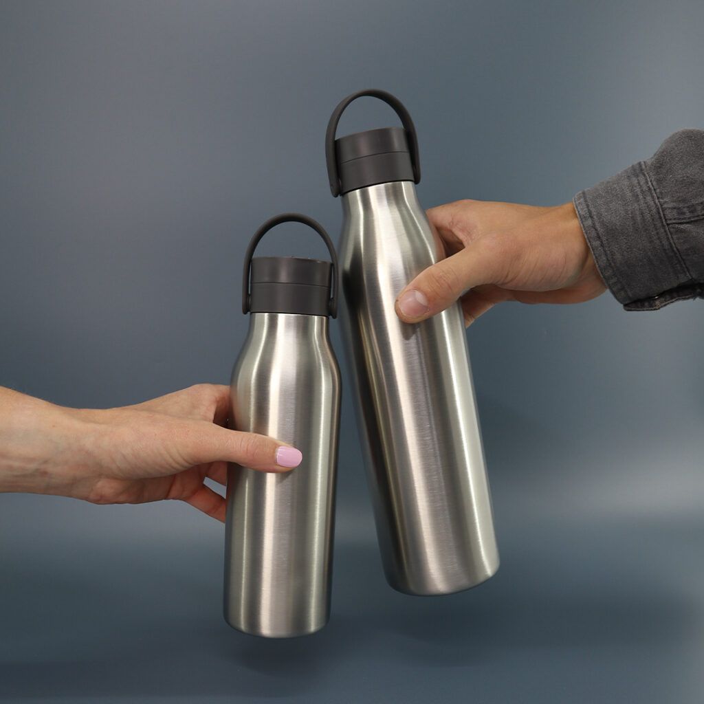 storm grey stainless steel water bottles being held 500ml and 1l